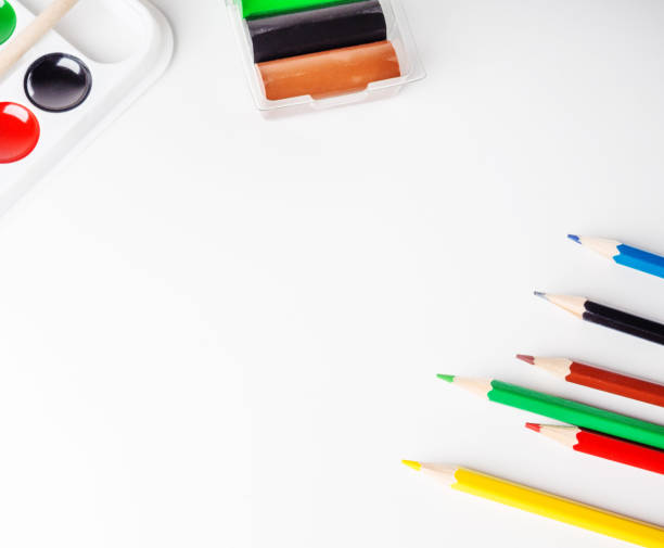 istock Watercolor paints, colored pencils on a white background 1015058614