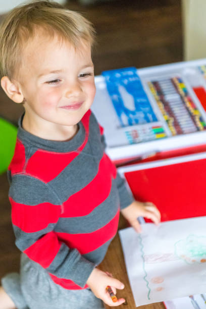 istock Smiling caucasian toddler playing drawing 1015064006