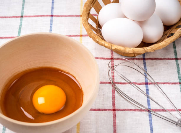 istock Bowl is yolk, eggs and a whisk for beating on a fabric background 1015067686