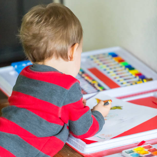 istock Smiling caucasian toddler playing drawing 1015067764