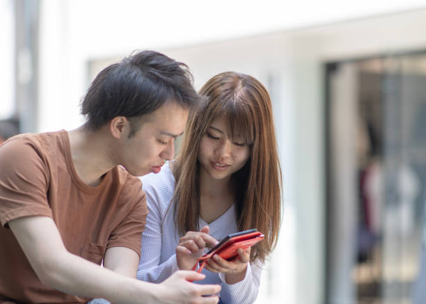 istock Young couple watching smartphone screen together 1015106966
