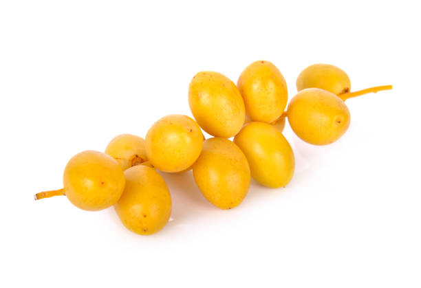 bunch of fresh yellow dates on white background