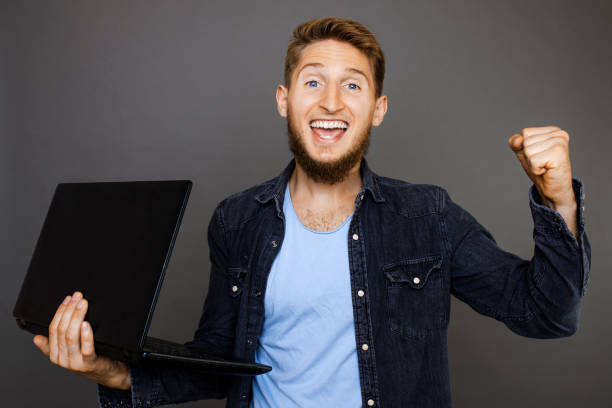 istock Man with laptop celebrating success 1015117040