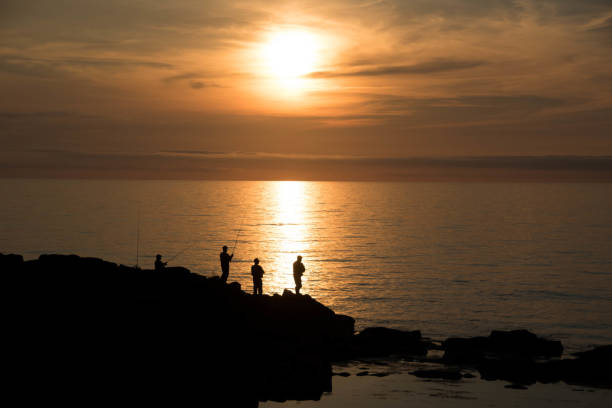 Quiet ocean dusk and angler