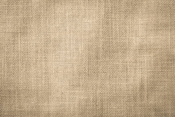 istock Hessian sackcloth woven texture pattern background in light cream yellow beige 1015120552