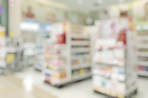 Pharmacy store or drugstore blur background with drug shelf and blurry pharmaceutical products, cosmetic and medication supplies on shelves inside retail shop interior Pharmacy store or drugstore blur background with drug shelf and blurry pharmaceutical products, cosmetic and medication supplies on shelves inside retail shop interior over the counter meds stock pictures, royalty-free photos & images