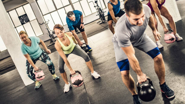 istock Fitness group doing kettlebell lifts 1015125744