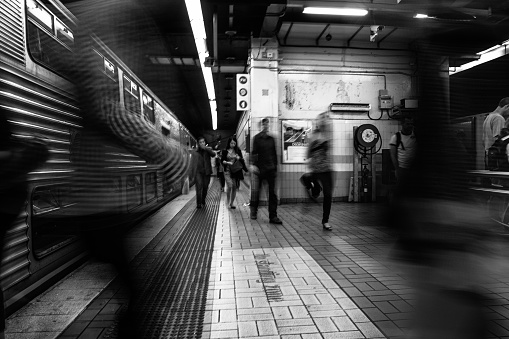 Sydney, NSW Australia April 14 2012  Train Station motion blur people walking in and out the train