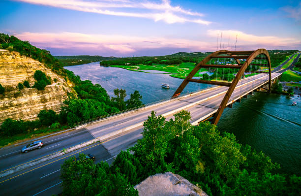 pink wraps the sky at pennybacker bridge - highway nobody town urban road imagens e fotografias de stock