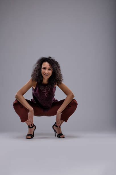 istock Attractive friendly woman squatting facing camera 1015144036