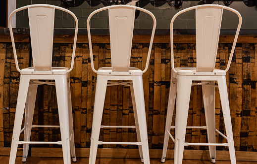 Three Tall Metal Stools at wooden bar