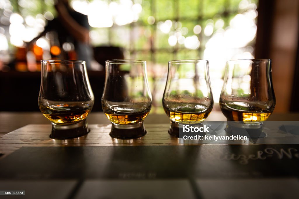 Bourbon Flight with selective focus Bourbon Flight with selective focus on four samples Bourbon Whiskey Stock Photo