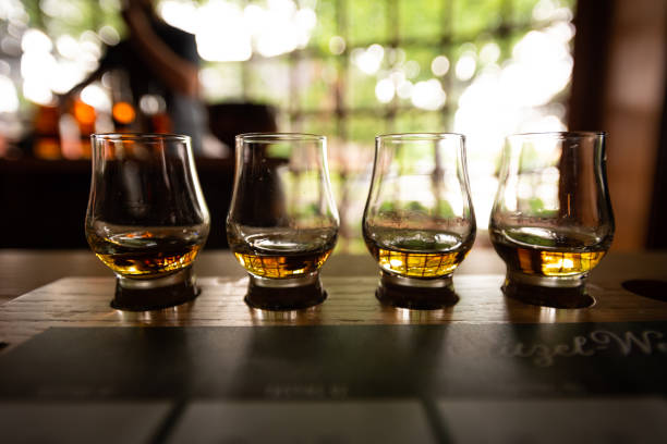 Bourbon Flight with selective focus Bourbon Flight with selective focus on four samples bourbon whiskey photos stock pictures, royalty-free photos & images