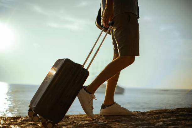 istock Tourist with suitcase by the sea 1015159854