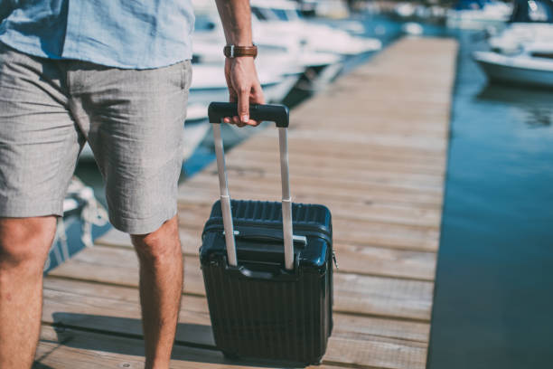 istock Tourist with suitcase on pier 1015160078