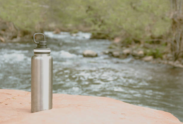 istock Vintage metal water bottle at river while hiking 1015165690