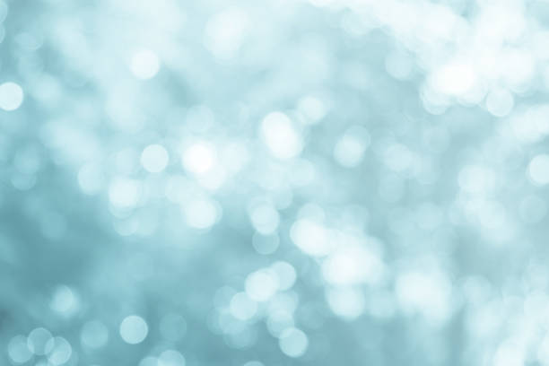 istock Blue and white lights defocused nature blurred or bokeh circles color snow glow colorful light sparkling under a tree with light survived abstract background. 1015169246