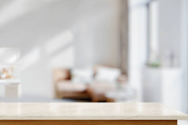 istock White marble top table for display montage over bright living room background. 1015180438
