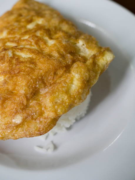 istock Thai food omelette topped with rice, Vertical view 1015180770