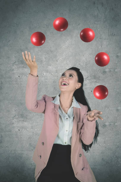 istock Beautiful entrepreneur juggling red balls 1015188442