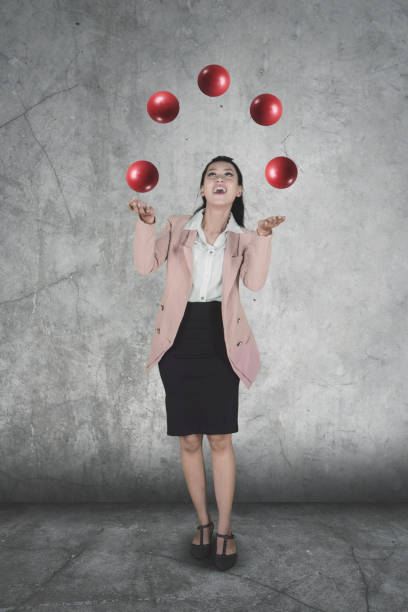 istock Female entrepreneur juggling red balls 1015188510