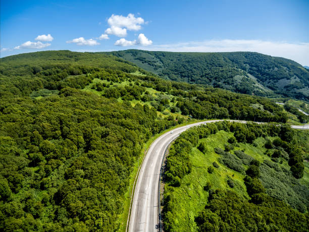 istock Aerial view at mountain road in sunny day 1015193564