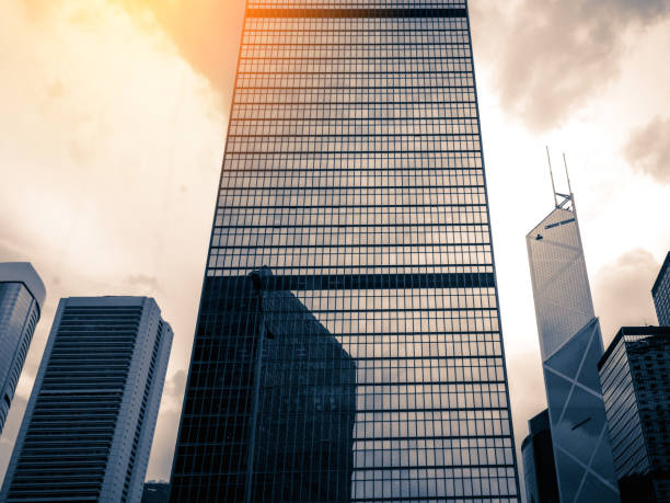 istock Bottom up view of Modern office building in Hong Kong with sunlight 1015200712