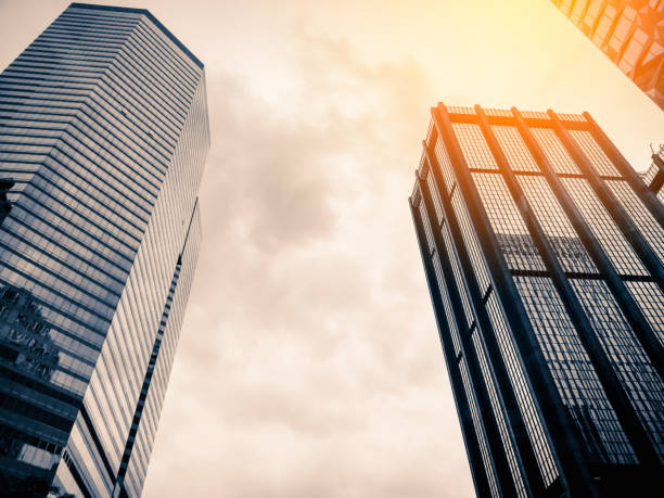 istock Bottom up view of Modern office building in Hong Kong with sunlight 1015200750