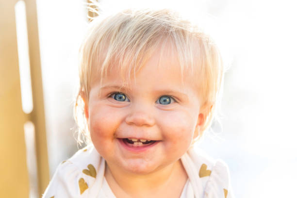 Caucasian Smiling baby girl looking at the camera