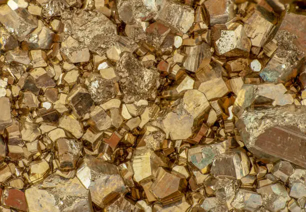 Golden color small pyrite cubes macro photo, background image