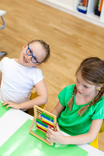 istock two beautiful Schoolgirls work together with the rake pusher 1015207178