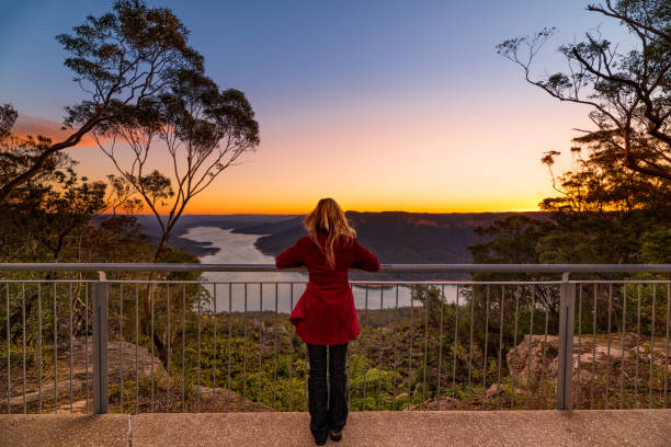 istock Female watching the sunset from Burragorang Lookout 1015209508