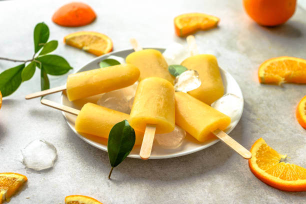 istock Orange popsicles with frozen juice and ice cubes, summer refreshing snack 1015214872