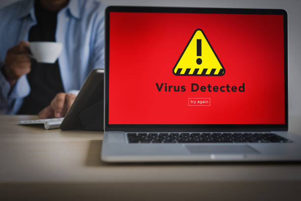 istock Hacker Protection Concept Man working on laptop Virus Detected Alert Digital Browsing Firewall 1015226068
