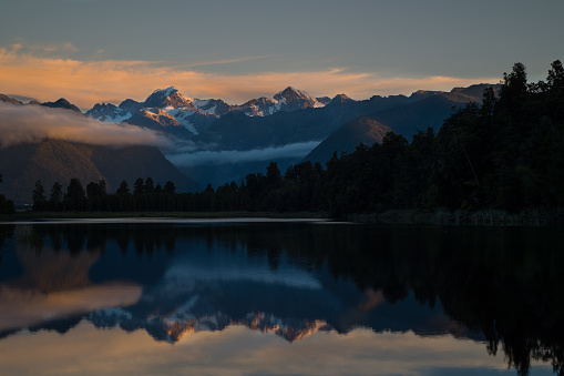 New Zealand's two tallest peaks, covered by glaciers in the middle of summer. This photo was taken at sunset, from inside a rainforest. The landscape diversity is breathtaking.