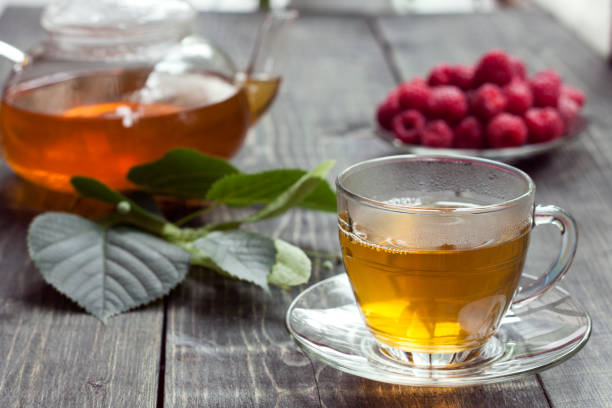 istock Raspberry and green tea from a linden on a wooden table 1015238252