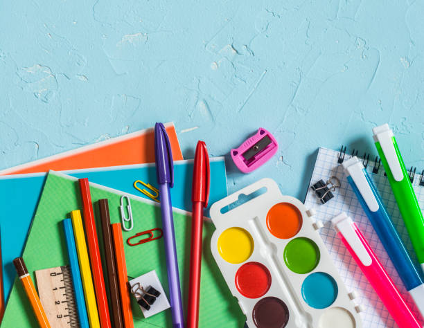 istock Back to school. School accessories - notebooks, pens, pencils, paint on a blue background, top view. Education concept. Flat lay, copy space 1015245314