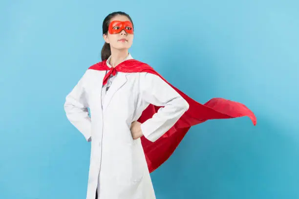 Photo of young female cancer doctor with superhero clothing