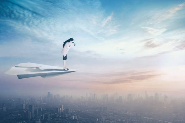 istock Businesswoman with paper plane and binoculars 1015246678
