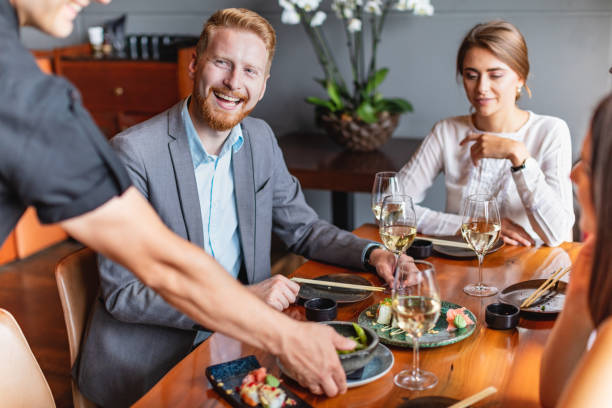 istock Business people served in sushi bar 1015247600