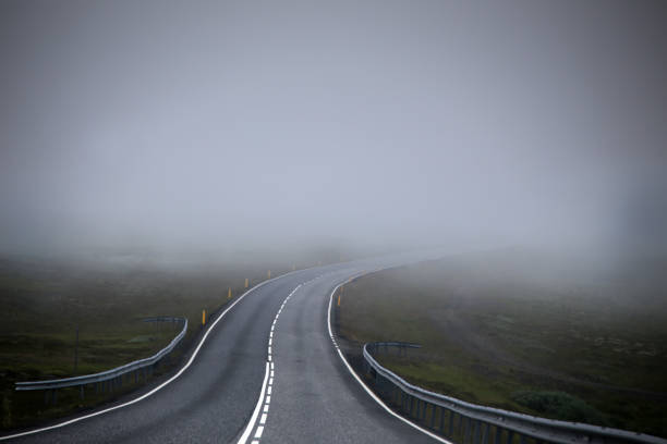 Road in fog (mist) Road in fog (mist). The picture was taken in Iceland in July 2017 Fog stock pictures, royalty-free photos & images