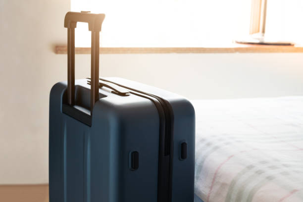 istock passenger luggage bag in bed room, ready for vacation 1015255078