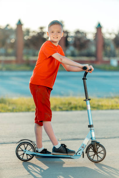 istock Cheerful Boy with Push Scooter on City Street 1015255662