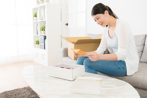 smiling elegant woman received present with letter on birthday.