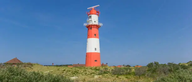 Panorama of the lighthouse on top of a dune in Borkum, Germany