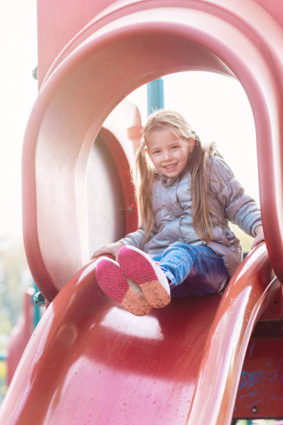 istock Little girl having fun on the playground 1015280410