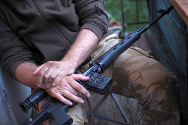istock soldier hands and Sniper rifle close up. war 1015280784