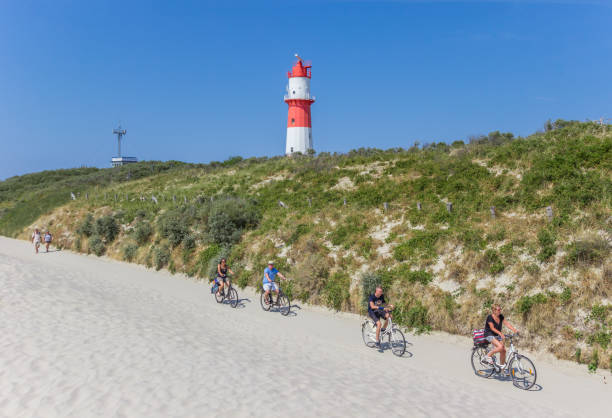 Borkum, Germany - July 25, 2018: People riding their bicycle on Borkum island, Germany