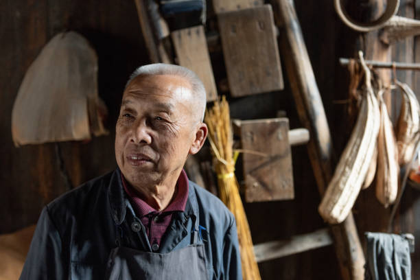 istock chinese senior man in old wooden barn 1015283566