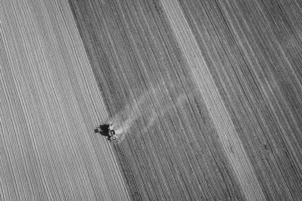 istock Tractor Plowing Aerial B&W 1015284286